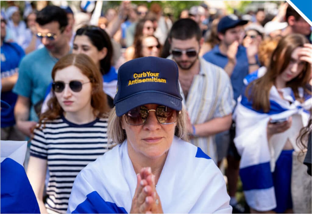 A woman wears a hat that reads Curb Your Antisemitism during a rally against campus antisemitism at George Washington University on May 2 - Photo by Andrew Harnik via Getty Images