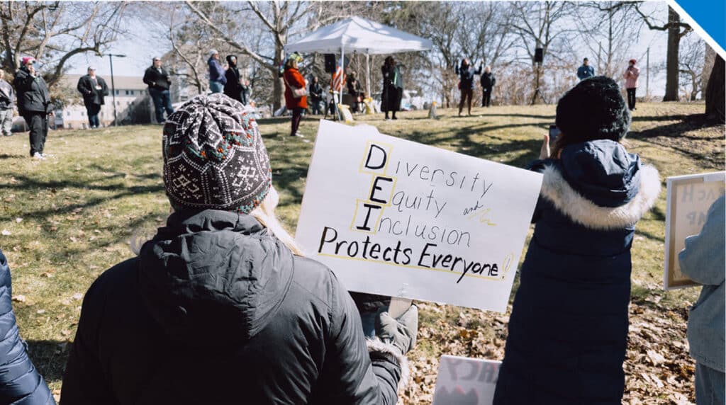 Picture of protestors holding sign Divrsity Equity and Inclusion protects everyone - Photo by Mark Scheuern Alamy Stock Photo