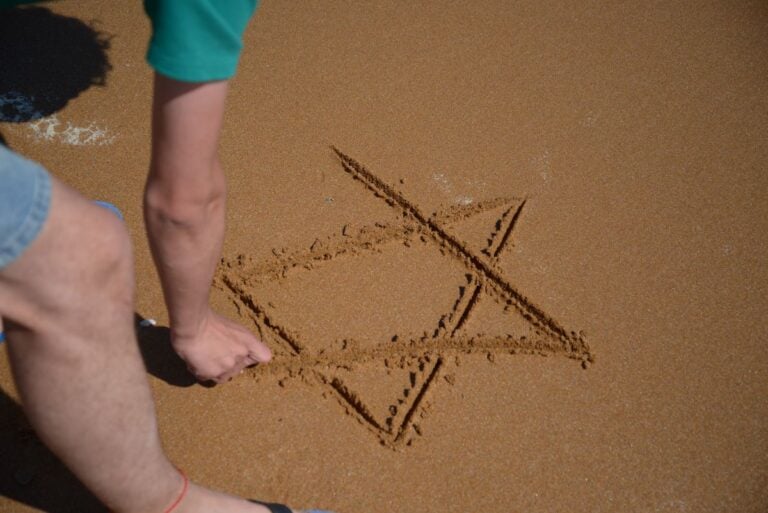 Star of David skietched in sand on a beach