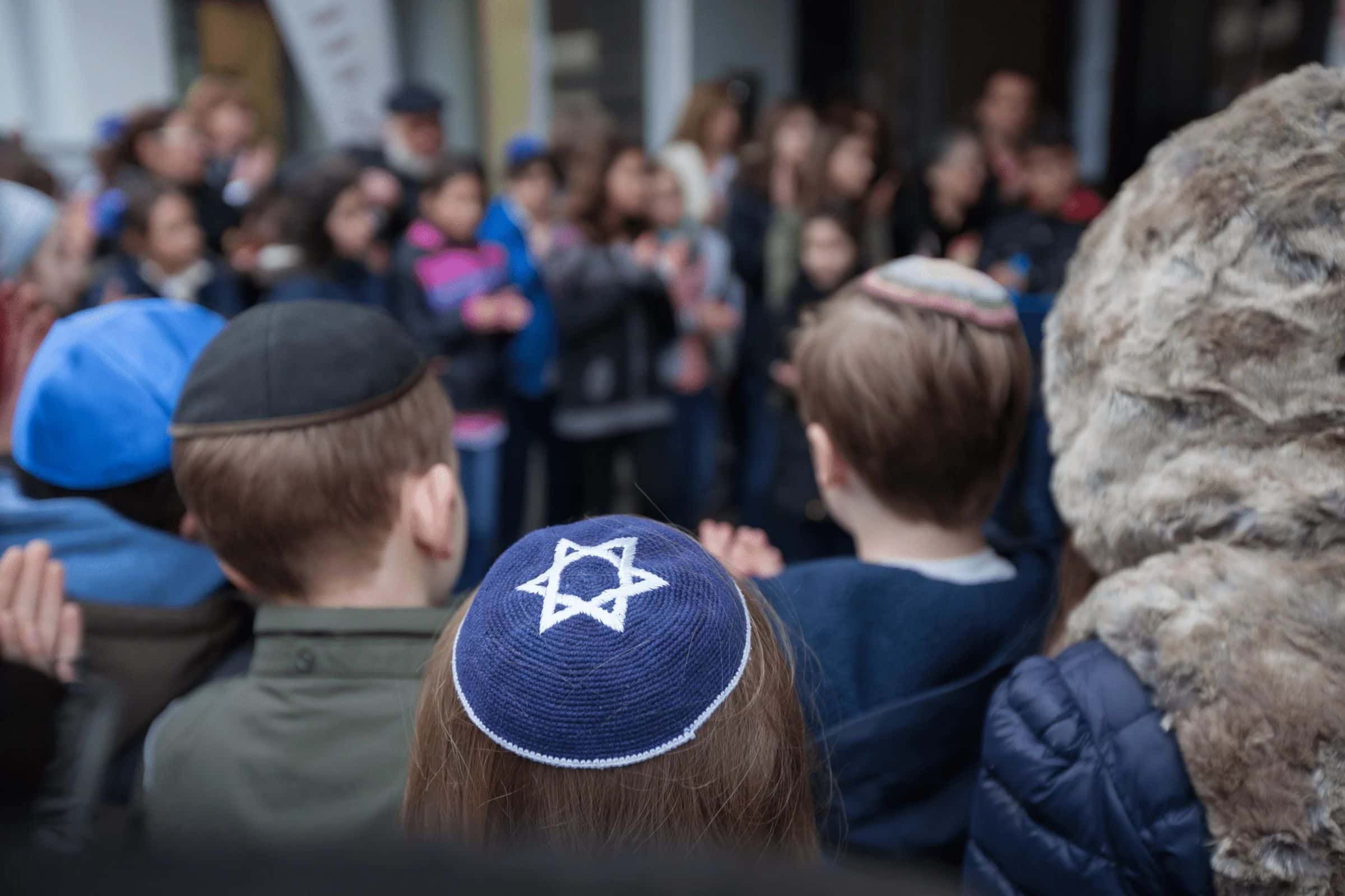 Jewish children wearing kippot at a rally.